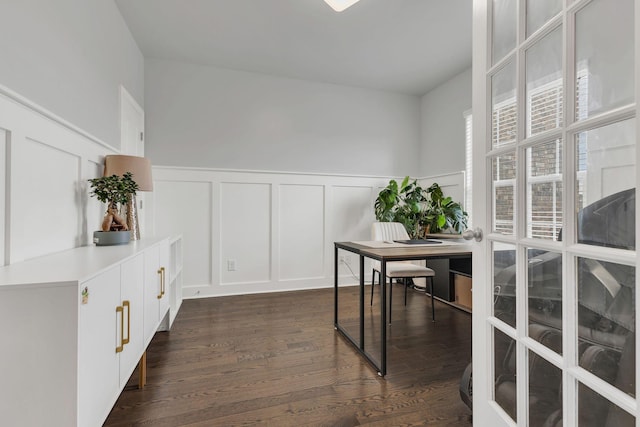 office featuring dark wood-type flooring, a wainscoted wall, and a decorative wall