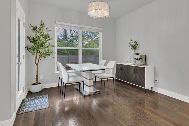 dining room featuring dark wood-type flooring, baseboards, and an inviting chandelier