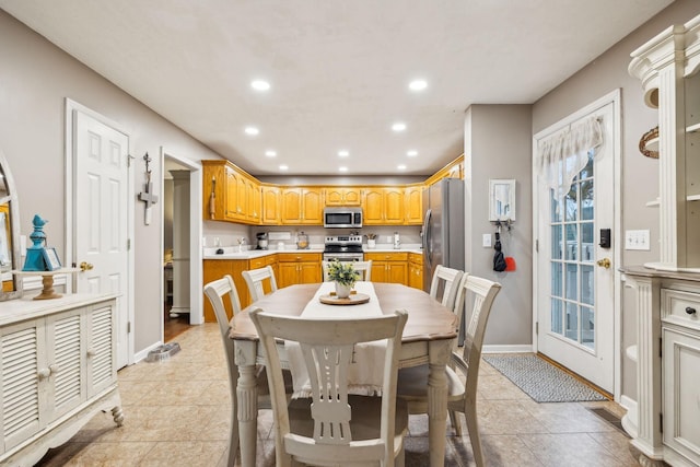 dining area with baseboards, light tile patterned floors, and recessed lighting