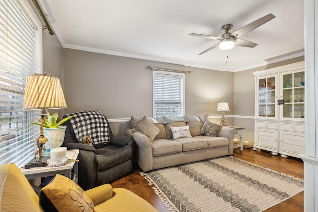 living room with ornamental molding, wood finished floors, and a ceiling fan