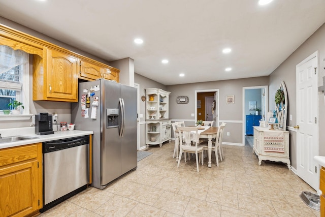 kitchen with baseboards, light countertops, appliances with stainless steel finishes, and recessed lighting