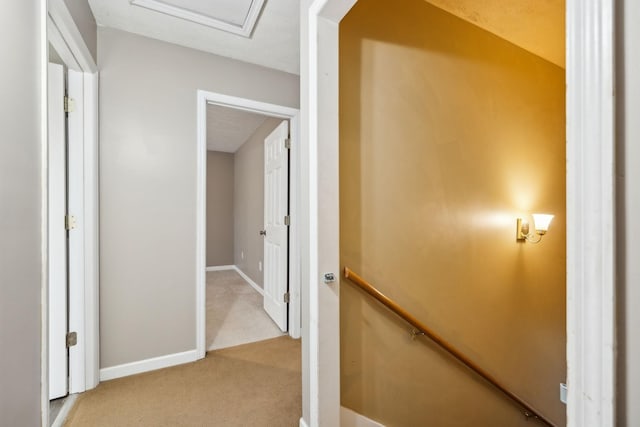 corridor with carpet and baseboards