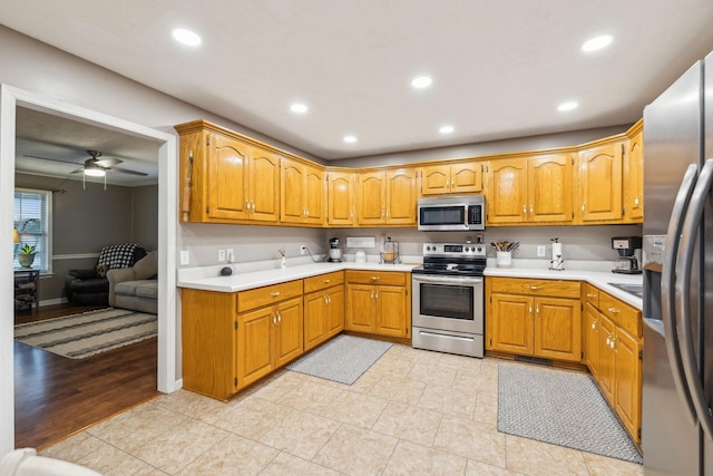 kitchen with appliances with stainless steel finishes, recessed lighting, and light countertops