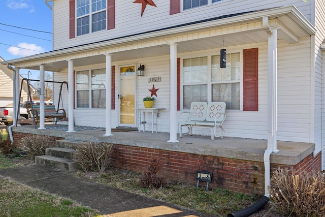 view of exterior entry featuring a porch