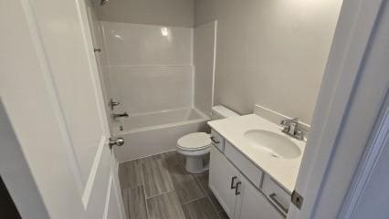 bathroom with toilet, shower / tub combination, wood tiled floor, and vanity