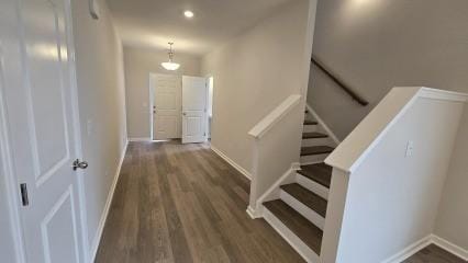 interior space with stairs, dark wood-type flooring, recessed lighting, and baseboards