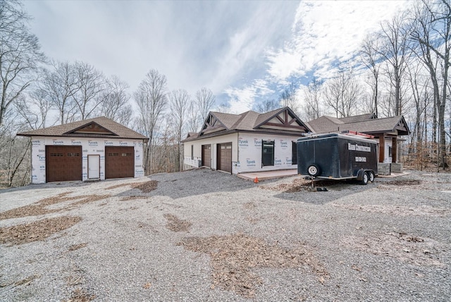 property under construction featuring an outdoor structure and a detached garage