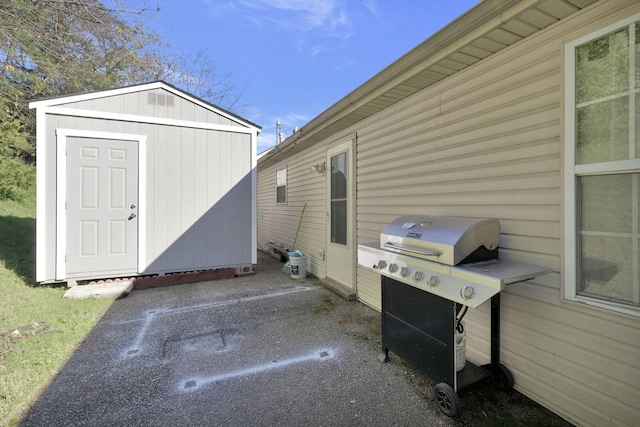 view of patio / terrace featuring a shed, an outbuilding, and area for grilling