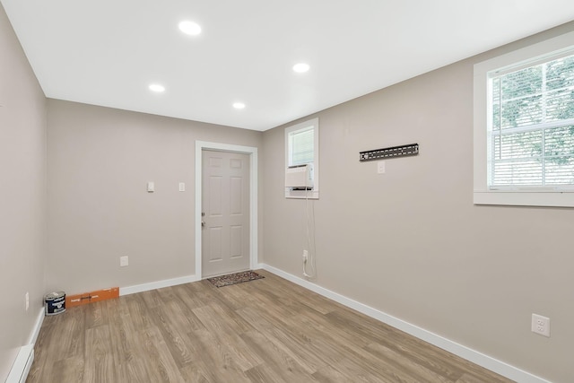 unfurnished room with recessed lighting, light wood finished floors, baseboards, and baseboard heating