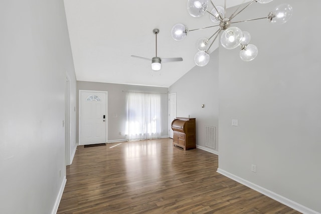 interior space with dark wood-style floors, baseboards, visible vents, and high vaulted ceiling