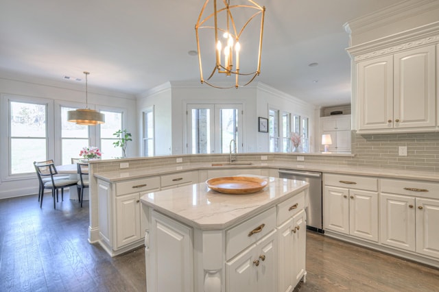 kitchen with a peninsula, white cabinetry, hanging light fixtures, a center island, and dishwasher