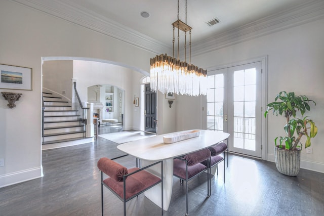 dining room featuring a healthy amount of sunlight, stairs, dark wood-style flooring, and french doors