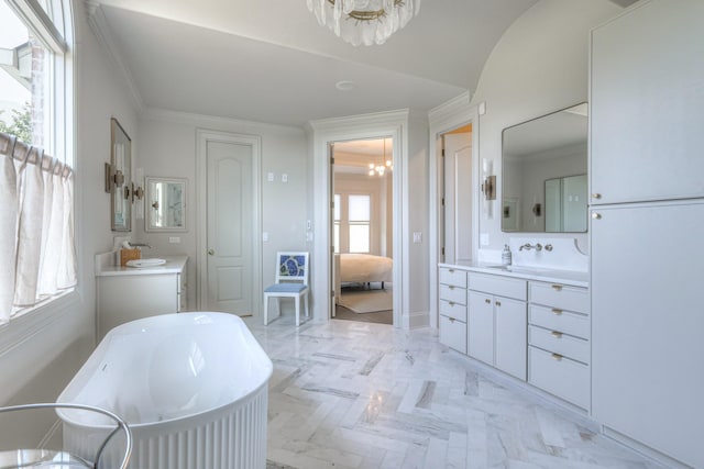 ensuite bathroom featuring two vanities, a notable chandelier, crown molding, and ensuite bathroom