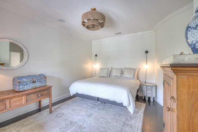 bedroom with baseboards, crown molding, visible vents, and dark wood-type flooring