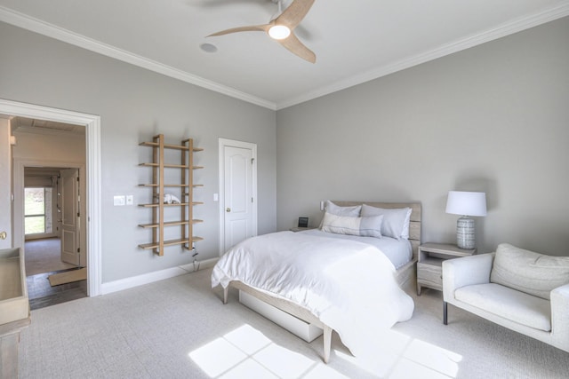 carpeted bedroom with baseboards, ceiling fan, and crown molding