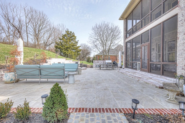 view of patio featuring an outdoor hangout area and a sunroom