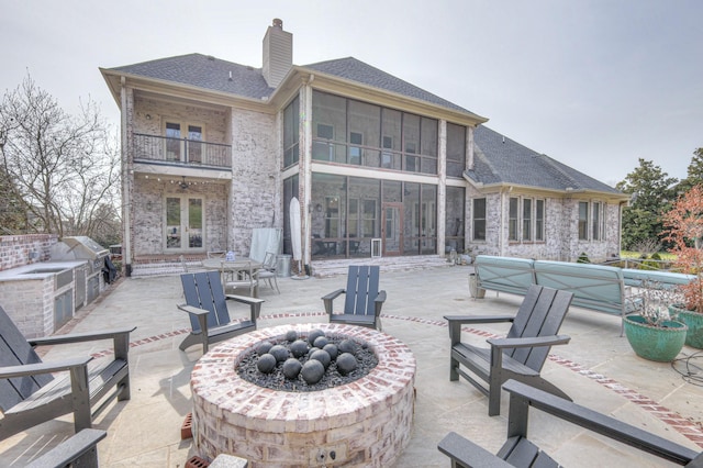 view of patio with french doors, an outdoor fire pit, and area for grilling