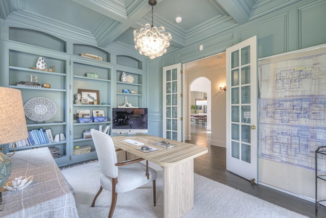 office space with arched walkways, built in shelves, a decorative wall, french doors, and ornamental molding