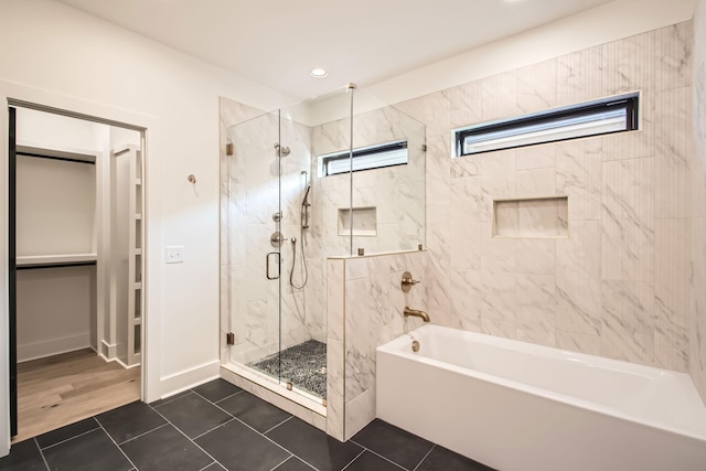605A Morrow Rd, Nashville, TN 37209 - bathroom with a garden tub, baseboards, tile patterned floors, a stall shower, and a walk in closet