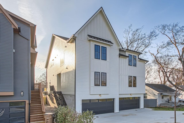 605A Morrow Rd, Nashville, TN 37209 - modern farmhouse style home featuring board and batten siding, a standing seam roof, metal roof, a garage, and stairs