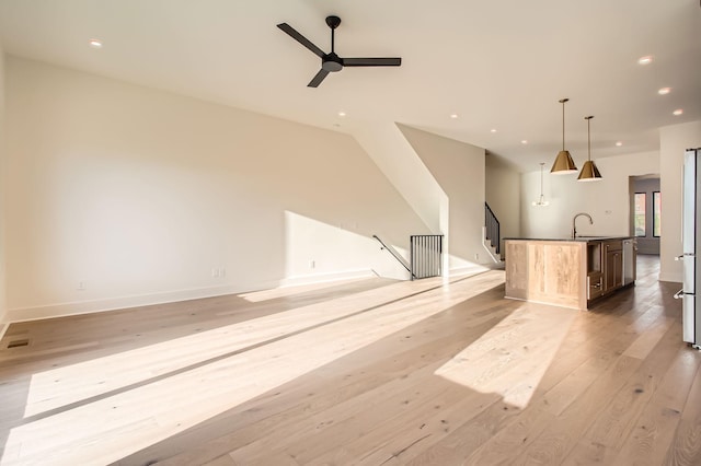 605A Morrow Rd, Nashville, TN 37209 - unfurnished living room with ceiling fan, recessed lighting, a sink, baseboards, and light wood-type flooring
