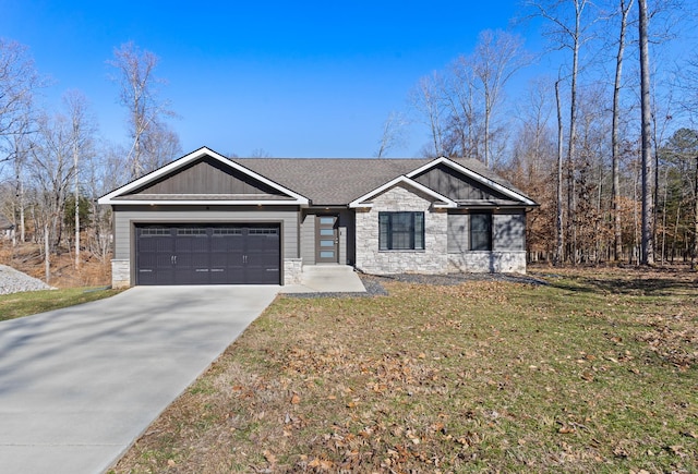 view of front of property featuring stone siding, a front lawn, an attached garage, and driveway