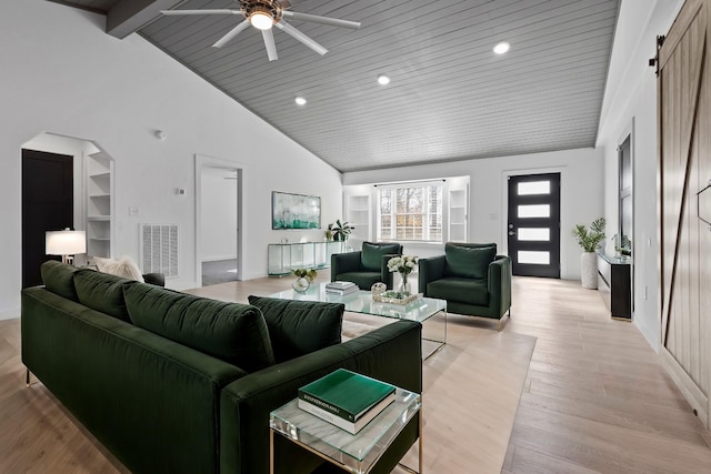 living room with arched walkways, high vaulted ceiling, light wood-style flooring, visible vents, and beam ceiling