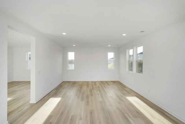 spare room with light wood-style floors, recessed lighting, and baseboards