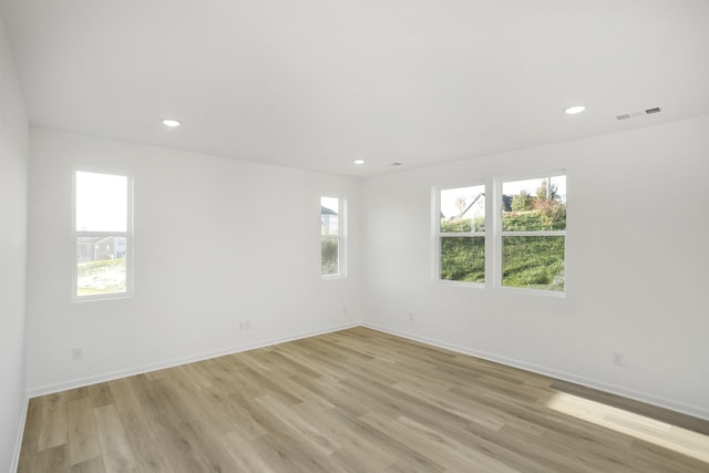 spare room with visible vents, baseboards, light wood-style flooring, and recessed lighting