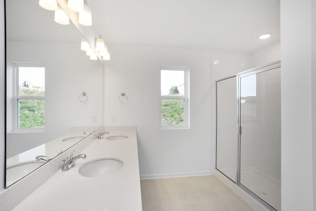 full bathroom with a wealth of natural light, a notable chandelier, and a sink