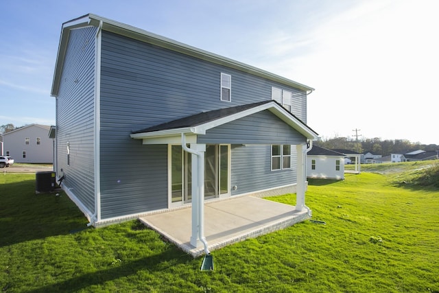 back of property featuring a patio area, central AC unit, and a yard