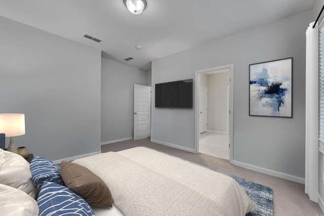 carpeted bedroom with visible vents and baseboards