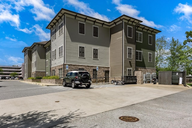 exterior space with uncovered parking and fence