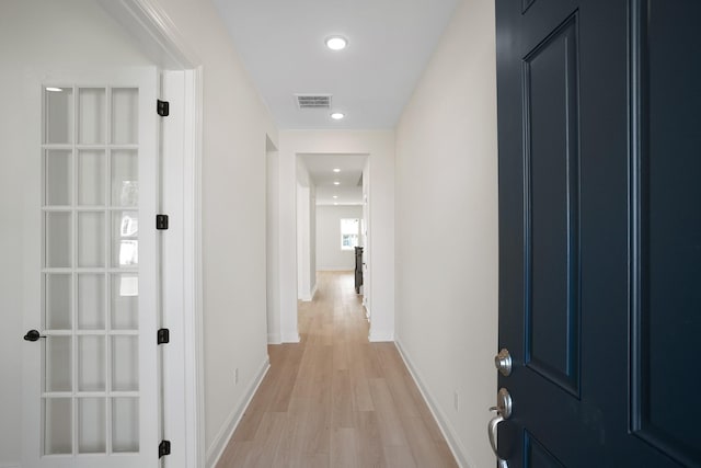 hall with recessed lighting, visible vents, light wood-style flooring, and baseboards