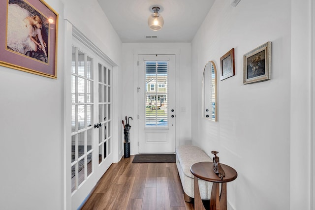 doorway to outside featuring visible vents and wood finished floors