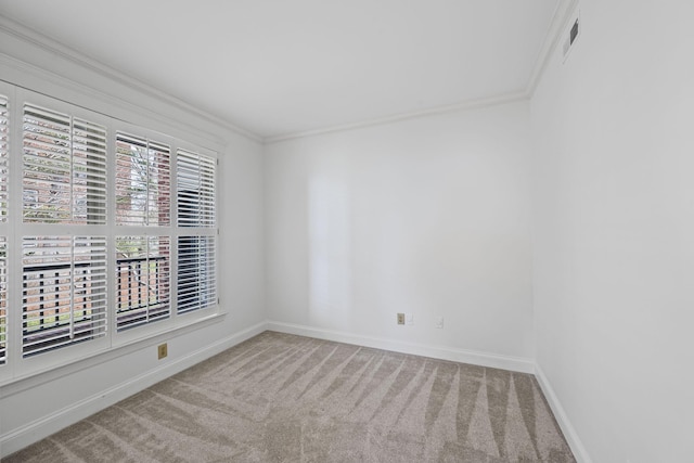 carpeted empty room with baseboards and crown molding