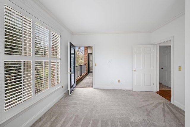 unfurnished bedroom with baseboards, carpet, and crown molding