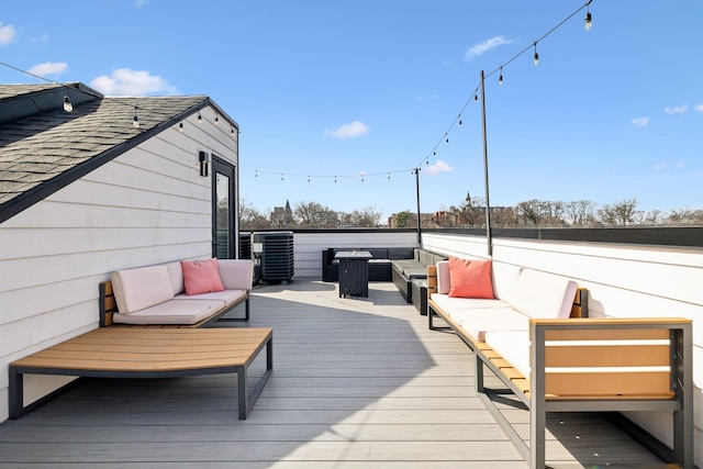 wooden terrace with an outdoor living space