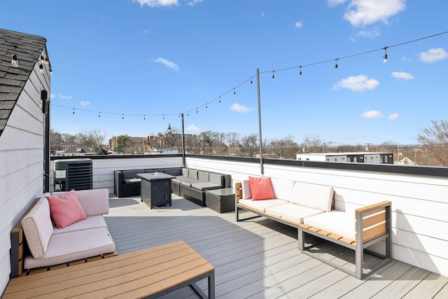 wooden deck with an outdoor living space with a fire pit