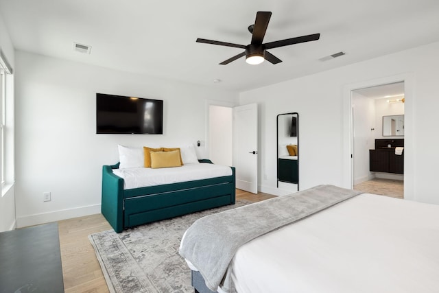 bedroom featuring ceiling fan, wood finished floors, visible vents, and baseboards