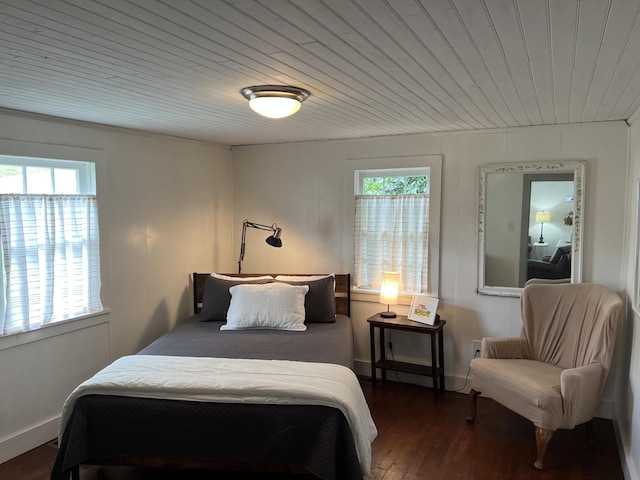 bedroom with dark wood-style floors, wood ceiling, and multiple windows