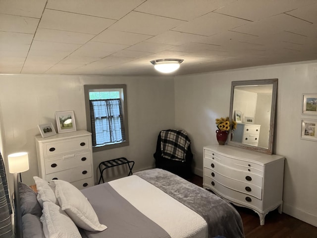 bedroom with dark wood finished floors