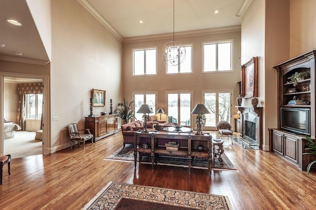 1225 Chloe Dr, Gallatin, TN 37066 - living area featuring a chandelier, wood finished floors, a high end fireplace, baseboards, and crown molding