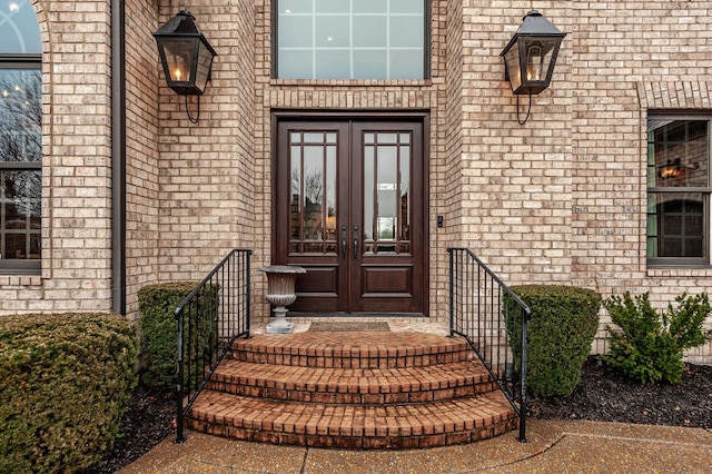 doorway to property with brick siding and french doors