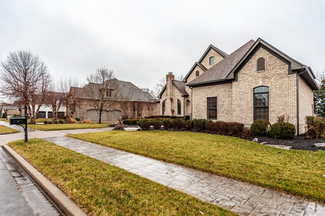 1225 Chloe Dr, Gallatin, TN 37066 - view of front of property featuring brick siding, a front lawn, and a shingled roof