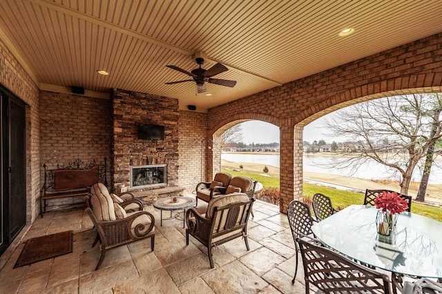 1225 Chloe Dr, Gallatin, TN 37066 - view of patio featuring outdoor dining space, a water view, and an outdoor living space with a fireplace