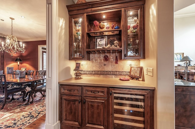 1225 Chloe Dr, Gallatin, TN 37066 - bar featuring wine cooler, ornamental molding, a bar, pendant lighting, and backsplash