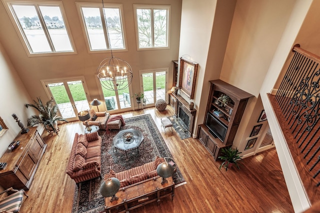 1225 Chloe Dr, Gallatin, TN 37066 - living area with a towering ceiling, a fireplace, a chandelier, and wood finished floors