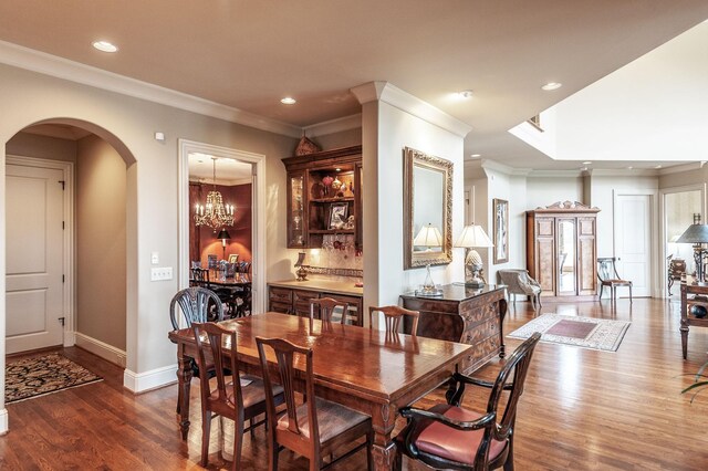 1225 Chloe Dr, Gallatin, TN 37066 - dining area with arched walkways, recessed lighting, dark wood-type flooring, baseboards, and an inviting chandelier