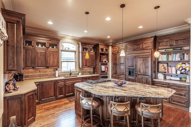 1225 Chloe Dr, Gallatin, TN 37066 - kitchen with decorative light fixtures, a sink, glass insert cabinets, and a center island